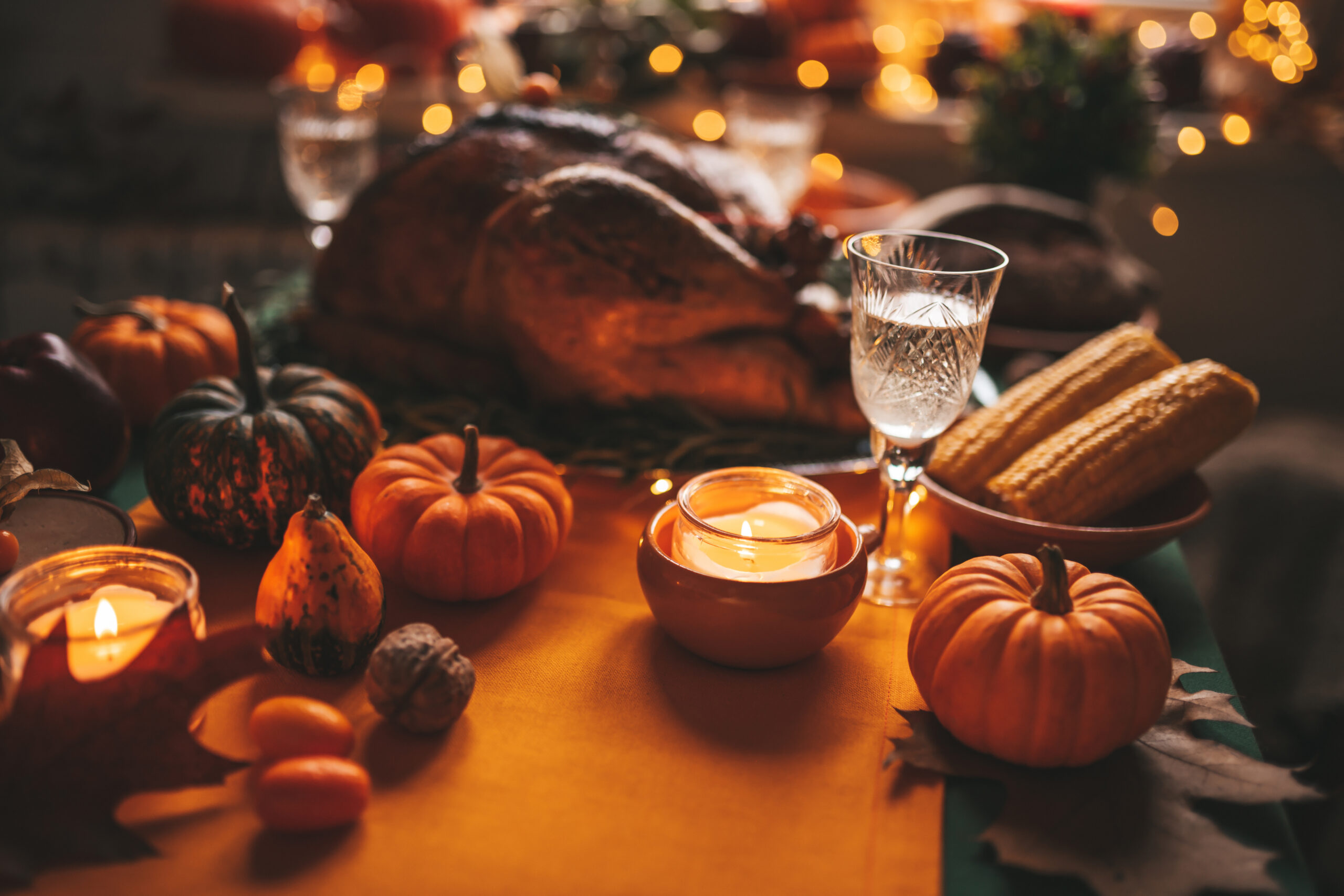 Thanksgiving holiday dinner table setting with fall decoration and pumpkins